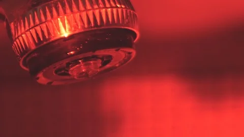 Turning on the shower in the red bathroom Stock Footage 116799138