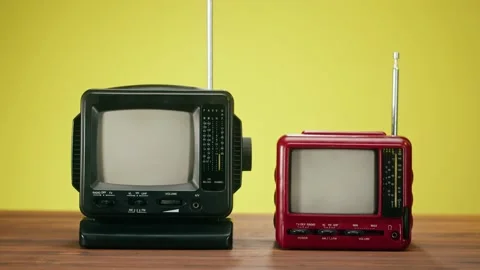 Turning on small old televisions with grey interference screen on yellow Stock Footage 169114164