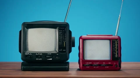 Turning on small old televisions with grey interference screen on blue Stock Footage 169114645