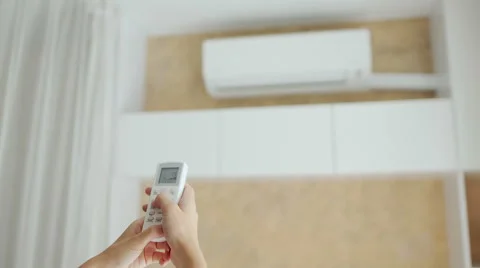 Turning on split system air conditioner with remote control. Stock Footage 66455658