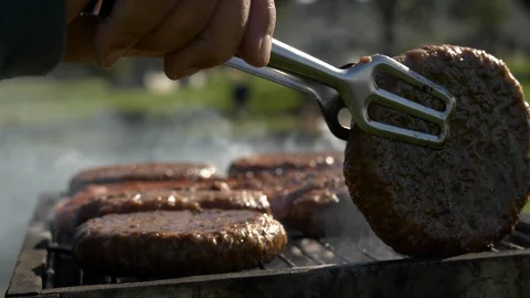 Turning tasty cutlets at grill close up Stock Footage 103225447
