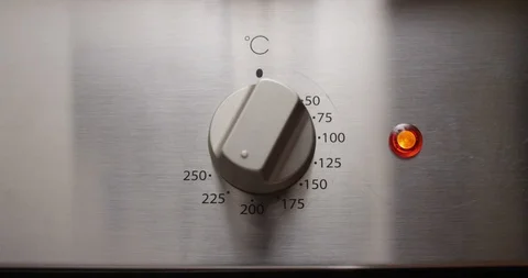 Turning on Temperature Switch Knob on a Gas Electric Stove Shot on Red 動画素材 102110802