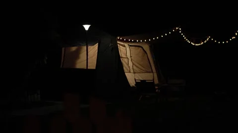 Turning Off a Tent Light Before Bedtime Stock Footage 346534041