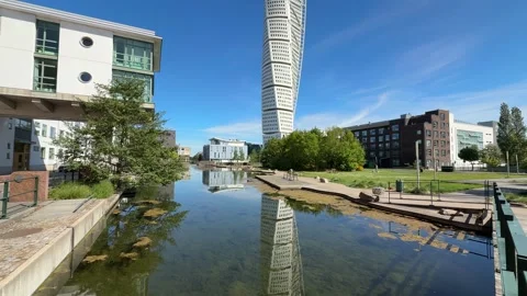 Turning Torso skyscraper reflection in canal water in Malmo city, Sweden Stock Footage 339287247