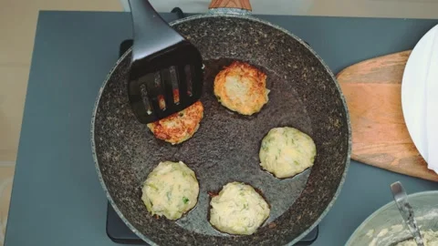 Turning vegetable cutlets to the other side Stock Footage 252428493