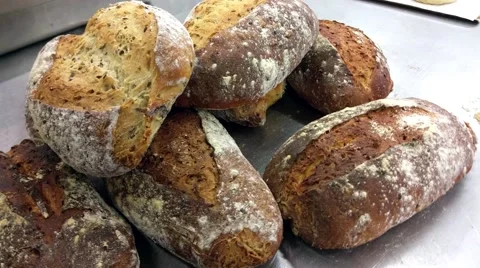 Turning view on a pile of homemade bread, at a bakery restaurant Stock Footage 57750064