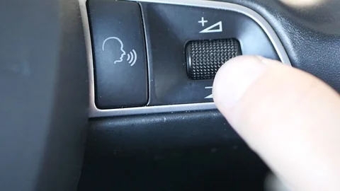 Turning volume up and down on car steering wheel Stock Footage 88411154