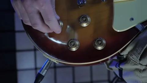 Turning volume and tone knobs on electric guitar at sound record studio 스톡 동영상 152413835