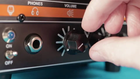 Turning up the volume dial on an amplifier, macro closeup Stock Footage 130572645