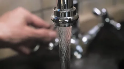 Turning on water to the kitchen sink close up Stock Footage 58339495