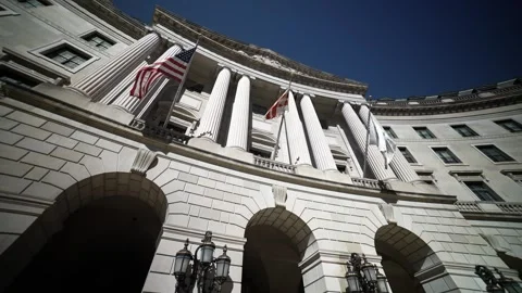 Turning wide angle view looking straight up at the flags and columns of the US Video stock 273981581
