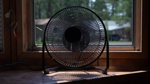 Turning on a window fan on a hot summer day Stock Footage 279196315