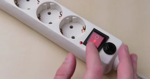 Turns on and off a surge protector for multiple outlets. Stock Footage 142151913