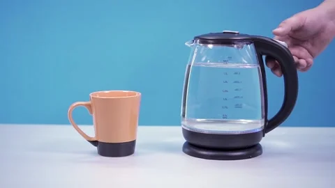 Turns on electric kettle blue Stock Footage 134835133