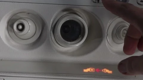 Turns on a light on board a passenger plane Stock Footage 144845780