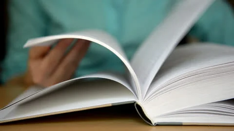Turns the pages of the book Stock Footage 24624024
