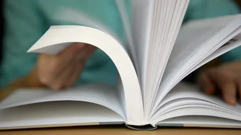 Turns the pages of the book Stock Footage 24624050