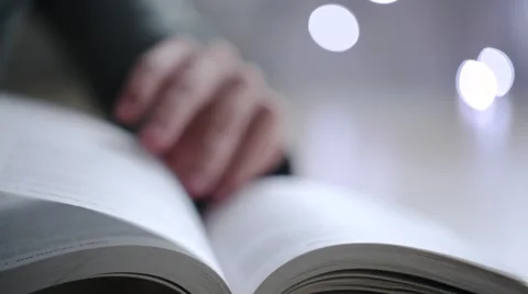 Turns the pages of the book Stock Footage 56427584