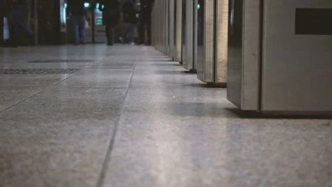 Turnstiles of a station with people in the background Stock Footage 71019873