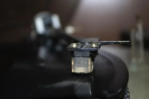 Turntable playing vinyl close up with needle on the record. Stock Photos