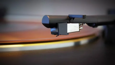 Turntable stylus playing vinyl record in warm retro light Stock Footage 320336203