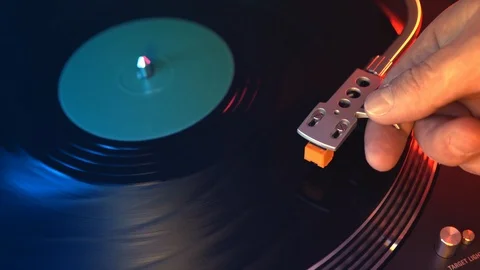 Turntable vinyl record player. The hand of a young man puts a vinyl record Stock Footage 91680738