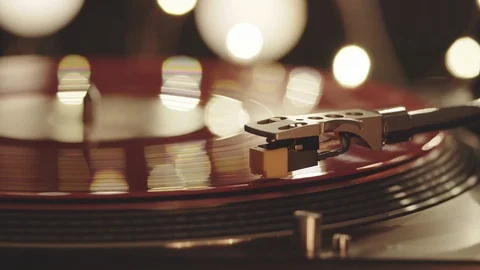 Turntable vinyl record player, red plate background with bright lights Stock Footage 94449189