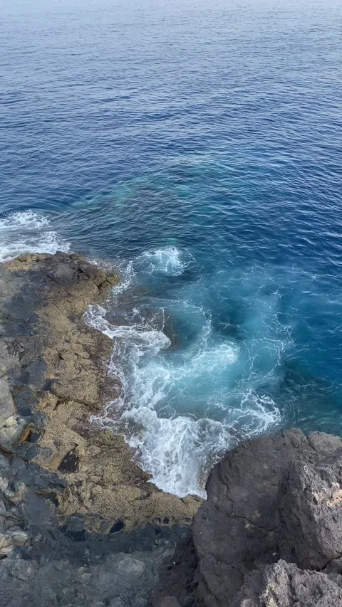 Turqouise blue Waves hit the rocks in La Gomera vulcano island Stock Footage