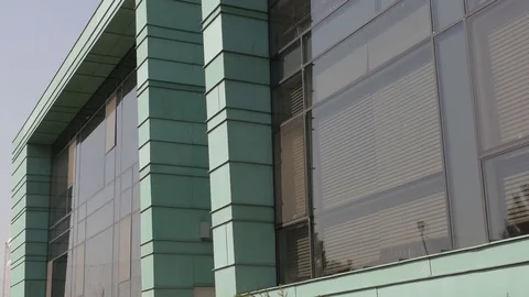 Turquise modern building, pine trees infront, close up 2 Stock Footage 74387181