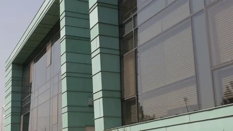 Turquise modern building, pine trees infront, close up 2 Stock Footage 75987069