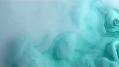 Turquoise and white inks are mixed in water. Use for backgrounds or overlays Stock Footage 132514596