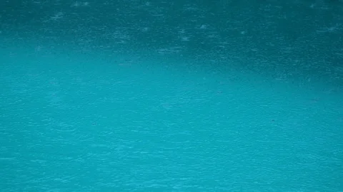 Turquoise background of a pool water surface under rain Stock Footage 120416070