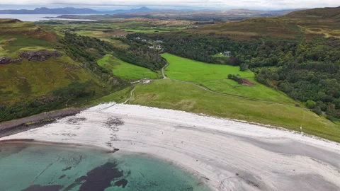 Turquoise Bay and White Sand Beach Surrounding Green Scottish Hills Stock Footage 346917400