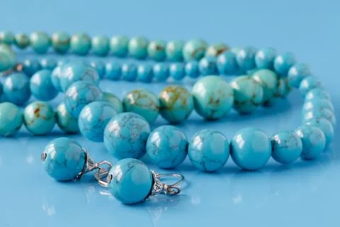 Turquoise beads on blue background Stock-Fotos