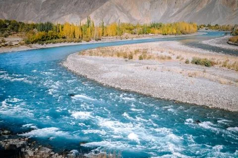Turquoise blue water of Gilgit river flowing through Ghizer. Gupis, Pakistan. Stock Photos