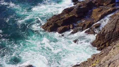 Turquoise blue wavex crash over the ocean rocks Stock Footage 157654448