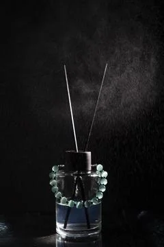 Turquoise Bracelet on Reed Diffuser Bottle with Water Spray in Dark Studio Stock Photos