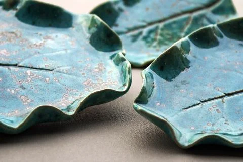 Turquoise ceramic plates with leaf imprint textured glaze Stock Photos