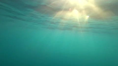 Turquoise clear ocean water with rays of the sun Video stock 293280509