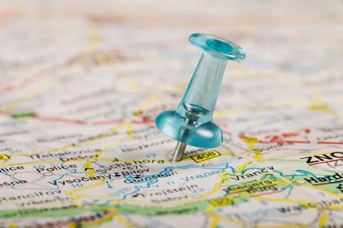 Turquoise colored pushpin stucked world map Stock Photos