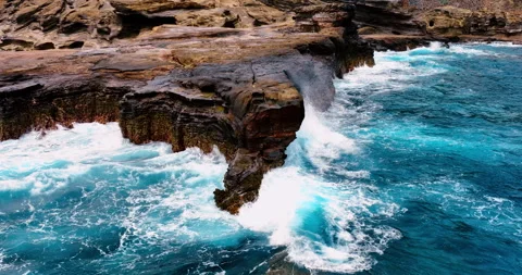 Turquoise deep ocean waters. Powerful waves crash with white foam and spray Stock Footage 311571994