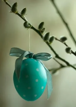 Turquoise easter egg hanging on wild pussy willow twig. Vertical orientation Stock Photos