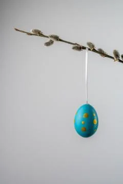 Turquoise easter egg hanging from a willow twig with catkins Stock Photos