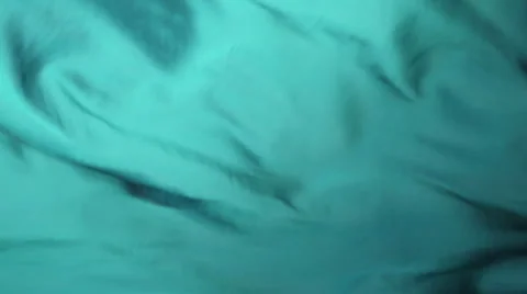 Turquoise fabric flows, Stock Footage 64533730