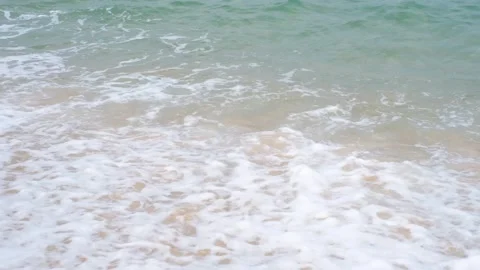 Turquoise foamy waves on a sandy beach close-up, natural background. Stock Footage 243873481