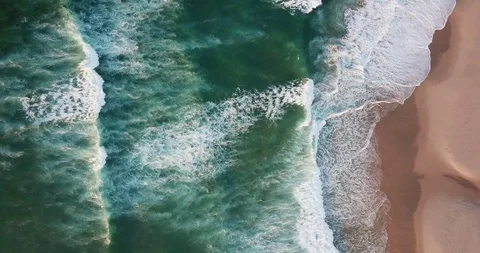 Turquoise frothy waves on the sandy shore of the Ogean from a bird's-eye view Stock Footage 130168876
