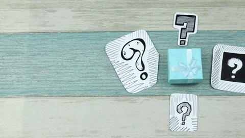Turquoise gift box under questions Stock Footage 90449508