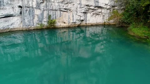Turquoise karst spring and rock cliffs aerial view Video stock 327071883