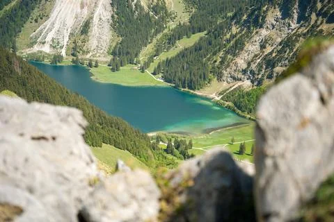 Turquoise Mountain Lake Surrounded by Pine Forests and Alpine Meadows Seen .. Stock Photos