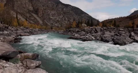 A turquoise mountain river flows violently among the stones. Stock Footage 162198200